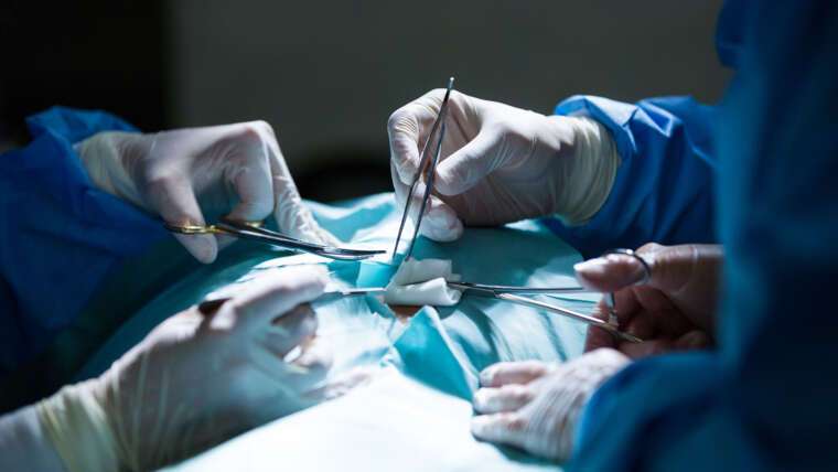 surgeons performing operation operation room