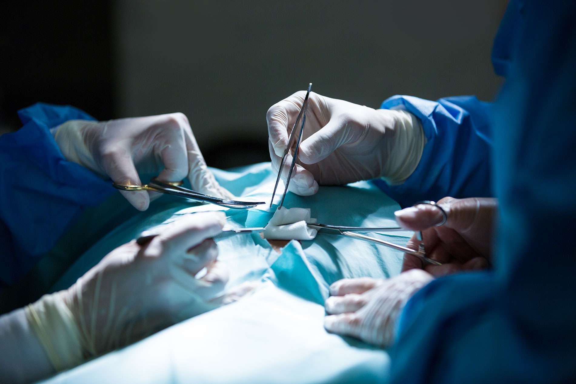 surgeons performing operation operation room